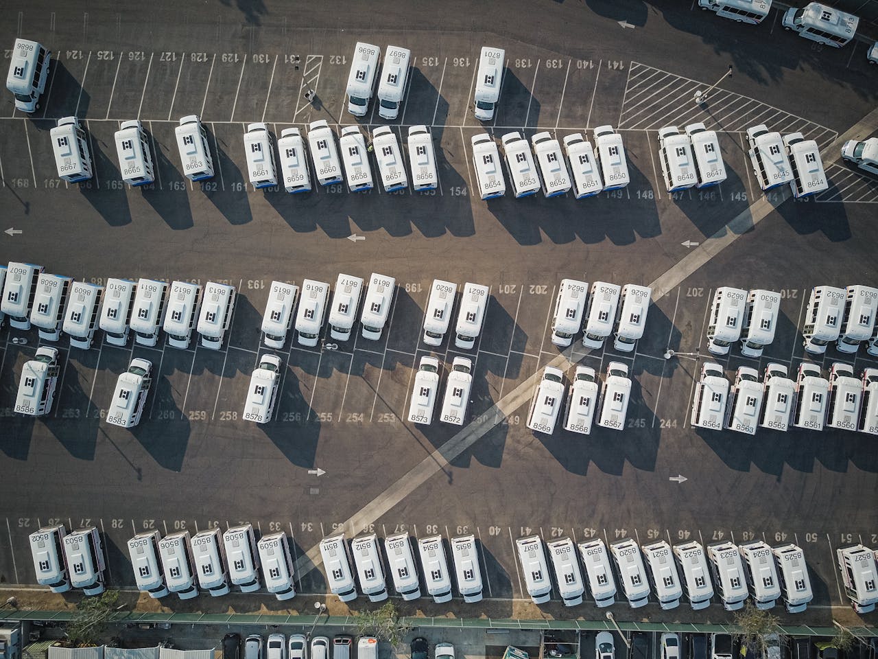 Aerial perspective showcasing a parking lot filled with parked camper vans.